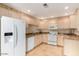 Well-lit kitchen with granite countertops, white appliances, and light wood cabinets at 15252 N 100Th St # 1151, Scottsdale, AZ 85260