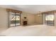 Open living room with fireplace and sliding doors to patio at 15252 N 100Th St # 1151, Scottsdale, AZ 85260