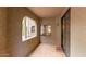 Relaxing, enclosed patio space with tile flooring, an arched window, and a sliding glass door at 15252 N 100Th St # 1151, Scottsdale, AZ 85260