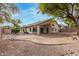 A spacious backyard featuring a covered patio and mature trees at 16510 W Baden Ave, Goodyear, AZ 85338