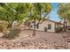 A spacious backyard featuring gravel and mature trees at 16510 W Baden Ave, Goodyear, AZ 85338