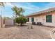 A spacious backyard featuring gravel and mature trees at 16510 W Baden Ave, Goodyear, AZ 85338