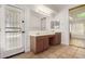 Bright bathroom featuring a double sink vanity with a door leading to the outside at 16510 W Baden Ave, Goodyear, AZ 85338