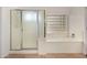 Bright bathroom featuring a glass door shower and separate tub with glass block window at 16510 W Baden Ave, Goodyear, AZ 85338