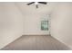 Carpeted bedroom with a ceiling fan, base molding, and window at 16510 W Baden Ave, Goodyear, AZ 85338