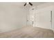 Bedroom featuring neutral carpet, ceiling fan, and a double door closet at 16510 W Baden Ave, Goodyear, AZ 85338