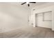 Carpeted bedroom with a ceiling fan, base molding, and closet at 16510 W Baden Ave, Goodyear, AZ 85338