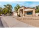 Charming single-story home featuring a desert landscape, neutral colors, and a welcoming front porch at 16510 W Baden Ave, Goodyear, AZ 85338