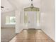 Bright foyer with tiled floors and decorative lighting leading into an open living space at 16510 W Baden Ave, Goodyear, AZ 85338