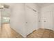 Tiled hallway featuring closet space and views into other rooms of the house at 16510 W Baden Ave, Goodyear, AZ 85338