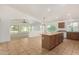 Open kitchen with an island, dining area, and modern appliances at 16510 W Baden Ave, Goodyear, AZ 85338