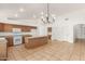Spacious kitchen with an island, tile floors, and modern appliances provides a functional and inviting space for cooking and dining at 16510 W Baden Ave, Goodyear, AZ 85338