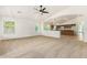Open living room connects to kitchen with large windows, offering a bright, airy feel at 16510 W Baden Ave, Goodyear, AZ 85338