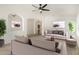 Bright living room with neutral decor, ceiling fan, and views into other rooms for open living at 16510 W Baden Ave, Goodyear, AZ 85338