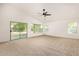 Bright living room with large windows and sliding glass doors overlooking the backyard provides a seamless indoor-outdoor flow at 16510 W Baden Ave, Goodyear, AZ 85338