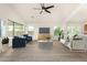 Bright living room featuring modern furniture, a ceiling fan, and large windows for ample natural light at 16510 W Baden Ave, Goodyear, AZ 85338