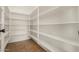 Spacious walk-in pantry with white shelves, offering generous storage for an organized kitchen at 16510 W Baden Ave, Goodyear, AZ 85338