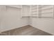 Walk-in closet with built-in shelving and lots of storage space at 16510 W Baden Ave, Goodyear, AZ 85338