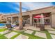 A covered patio offers an outdoor dining and lounge area with views of the pool and manicured lawn at 1668 E Saltsage Dr, Phoenix, AZ 85048