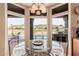 Bright breakfast nook featuring a round glass table with views of the backyard pool and golf course at 1668 E Saltsage Dr, Phoenix, AZ 85048