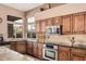 Well-appointed kitchen featuring stainless steel appliances, granite countertops, and custom wood cabinets at 1668 E Saltsage Dr, Phoenix, AZ 85048