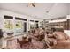 Bright living room with comfortable leather furniture and an easy indoor-outdoor flow to the pool and patio area at 1668 E Saltsage Dr, Phoenix, AZ 85048