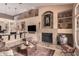 Bright living room featuring a stone fireplace, a TV, and an open floor plan perfect for entertaining at 1668 E Saltsage Dr, Phoenix, AZ 85048