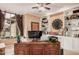 Dedicated home office space featuring built-in shelving, a large desk, and ample natural light at 1668 E Saltsage Dr, Phoenix, AZ 85048