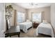 Charming bedroom with two twin beds, stylish decor, and a ceiling fan with lighting at 16801 N 94Th St # 2005, Scottsdale, AZ 85260