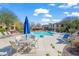 Community pool with ample seating, umbrellas, and lush landscaping at 16801 N 94Th St # 2005, Scottsdale, AZ 85260