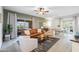 Bright living room with a comfortable leather sofa, stylish decor, and access to a balcony at 16801 N 94Th St # 2005, Scottsdale, AZ 85260