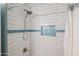 Close up of shower with white subway tile and decorative blue accent at 16801 N 94Th St # 2005, Scottsdale, AZ 85260