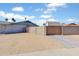 View of the backyard featuring desert landscaping, privacy walls, and a large gated entry at 16824 N 38Th Dr, Phoenix, AZ 85053