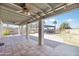 Spacious covered patio with ceiling fan and extended brick-paved yard for outdoor enjoyment at 16824 N 38Th Dr, Phoenix, AZ 85053