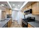 Well-lit kitchen featuring wood cabinets, stainless steel appliances, and granite countertops at 16824 N 38Th Dr, Phoenix, AZ 85053