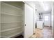 Well-equipped laundry room with shelving, washer, dryer, and convenient access to the backyard at 16824 N 38Th Dr, Phoenix, AZ 85053