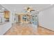 Open living space with custom shelving, sliding doors to patio, and eat-in kitchen at 16824 N 38Th Dr, Phoenix, AZ 85053