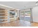 Living room features custom shelving and storage, TV, and backyard views through sliding glass doors at 16824 N 38Th Dr, Phoenix, AZ 85053
