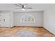 View of a spacious living room showing tile flooring, ceiling fan, and natural light from the arched window at 16824 N 38Th Dr, Phoenix, AZ 85053