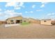 Wide shot of a spacious backyard with artificial turf, gravel landscaping and storage shed at 18438 W Brookwood Dr, Goodyear, AZ 85338