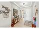 Inviting entryway with tile flooring, decorative console table, and elegant lighting fixtures creating a warm and welcoming ambiance at 18438 W Brookwood Dr, Goodyear, AZ 85338