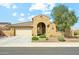 Charming single-story home with a well-manicured front yard and a two-car garage, complemented by a beautiful blue sky at 18438 W Brookwood Dr, Goodyear, AZ 85338