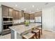 Stylish kitchen with stainless steel appliances, granite countertops, and an island with seating, perfect for cooking and entertaining at 18438 W Brookwood Dr, Goodyear, AZ 85338