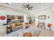 Expansive living room with tile flooring, open to the kitchen, perfect for modern living and entertaining guests at 18438 W Brookwood Dr, Goodyear, AZ 85338