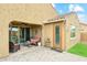 A cozy covered outdoor patio with comfortable seating and brick pavers, perfect for relaxation at 18438 W Brookwood Dr, Goodyear, AZ 85338