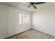Neutral bedroom features a ceiling fan and a window to allow natural light at 1935 W Morten Ave # 17, Phoenix, AZ 85021