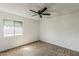 Bedroom featuring neutral carpeting, a ceiling fan, and a large window for natural light at 1935 W Morten Ave # 17, Phoenix, AZ 85021