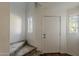Bright entryway with tiled floors, stairs, and a white front door at 1935 W Morten Ave # 17, Phoenix, AZ 85021