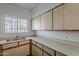Kitchen featuring white cabinets, stainless steel sink and plenty of counter space at 1935 W Morten Ave # 17, Phoenix, AZ 85021