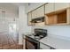 A view from the kitchen toward the adjacent dining and living rooms at 1935 W Morten Ave # 17, Phoenix, AZ 85021